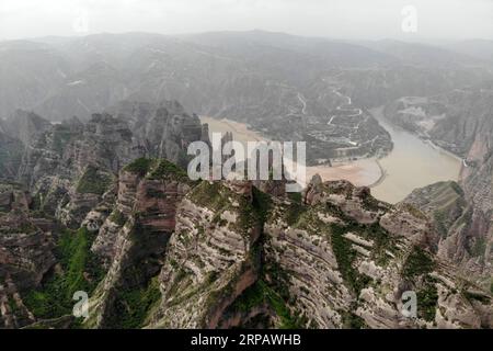 (190519) -- YONGJING, May 19, 2019 (Xinhua) -- Aerial photo taken on May 19, 2019 shows a stone forest at Bingling Danxia National Geological Park in Yongjing County, northwest China s Gansu Province. Danxia landform is a unique type of landscapes formed from red sandstone and characterized by steep cliffs. (Xinhua/Fan Peishen) CHINA-GANSU-YONGJING-DANXIA LANDFORM (CN) PUBLICATIONxNOTxINxCHN Stock Photo