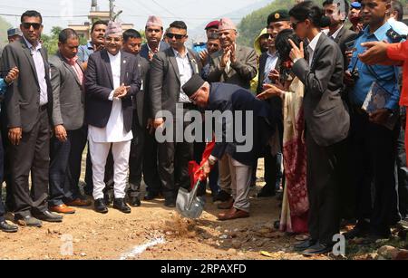 (190521) -- DHADING, May 21, 2019 -- Nepali Prime Minister KP Sharma Oli (C) participates in a ground breaking ceremony of laying the optical fibers at Galchhi Rural Municipality of Dhading District, in Western Kathmandu, May 20, 2019. China Communications Services International Limited started to lay optical fibers along a highway connecting the eastern and western border of Nepal for Nepal Telecom (NT), one of the biggest telecom service providers of Nepal. The Chinese company is responsible for laying 555 kilometers of optical fibers out of the planned 2,179-km long fibers from Chiyabhanjya Stock Photo