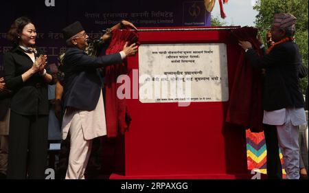 (190521) -- DHADING, May 21, 2019 -- Nepali Prime Minister KP Sharma Oli (2nd L) unveils a plaque in a ground breaking ceremony of laying the optical fibers at Galchhi Rural Municipality of Dhading District, in Western Kathmandu, May 20, 2019. China Communications Services International Limited started to lay optical fibers along a highway connecting the eastern and western border of Nepal for Nepal Telecom (NT), one of the biggest telecom service providers of Nepal. The Chinese company is responsible for laying 555 kilometers of optical fibers out of the planned 2,179-km long fibers from Chiy Stock Photo
