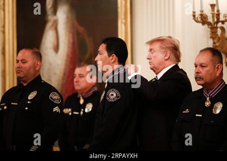 (190522) -- WASHINGTON, May 22, 2019 -- U.S. President Donald Trump (2nd R) presents the Public Safety Officer Medal of Valor to a recipient at the White House in Washington D.C., the United States, on May 22, 2019. ) U.S.-WASHINGTON D.C.-TRUMP TingxShen PUBLICATIONxNOTxINxCHN Stock Photo