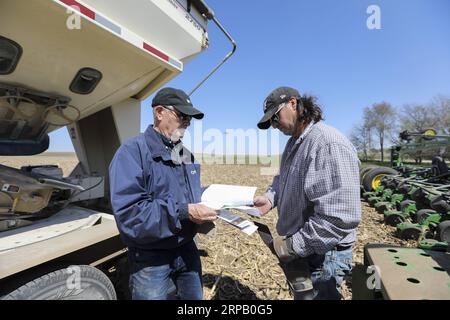 (190523) -- IOWA, May 23, 2019 (Xinhua) -- Bill Pellett and his son Bret checks the purchase record of corn seeds before planting at their family farm in Atlantic of Cass county, Iowa, the United States, April 24, 2019. Bill Pellett knows how to farm, but just like most of his peers across the country, the 71-year-old farmer is feeling less assured of what he could get from a new year of farming, as there appears to be no quick resolution of the year-long trade disputes between the United States and China. TO GO WITH Spotlight: Leading U.S. farming state enters new crop season amid uncertainty Stock Photo