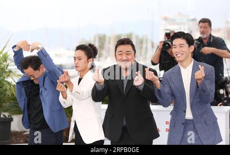 (190523) -- CANNES, May 23, 2019 (Xinhua) -- (L to R) Director Lee Won-tae, actors Kim Sung-Kyu, Ma Dong-Seok and Kim Moo-Yul pose during a photocall for The Gangster, The Cop, The Devil at the 72nd Cannes Film Festival in Cannes, France, May 23, 2019. (Xinhua/Gao Jing) FRANCE-CANNES-FILM FESTIVAL- THE GANGSTER, THE COP, THE DEVIL PUBLICATIONxNOTxINxCHN Stock Photo