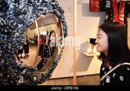 (190525) -- CHONGQING, May 25, 2019 (Xinhua) -- A visitor looks at an exhibit at a graduation exhibition of graduates from Sichuan Fine Arts Institute in Chongqing, southwest China, May 24, 2019. More than 10,000 pieces (sets) of works were displayed at the exhibition. (Xinhua/Wang Quanchao) CHINA-CHONGQING-ARTS-GRADUATES-EXHIBITION (CN) PUBLICATIONxNOTxINxCHN Stock Photo