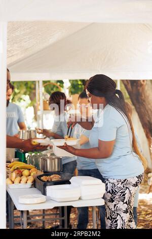 Volunteers giving food to homeless people Stock Photo - Alamy
