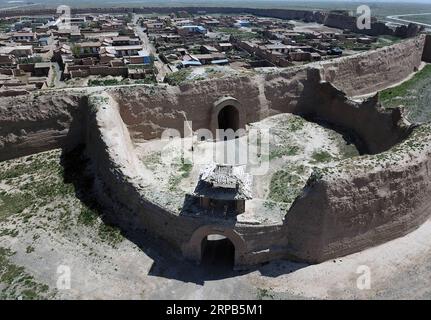 (190528) -- JINGTAI, May 28, 2019 (Xinhua) -- Aerial photo taken on May 28, 2019 shows the southern gate and barbican of the Yongtai ancient city in Jingtai County of Baiyin, northwest China s Gansu Province. Construction of the Yongtai ancient city began in the early 17th century and the complex used to be a military fortress. Girdled by 12-meter wall structures totaling 1.7 kilometers in length, the Yongtai ancient city looks like a turtle when seen from above and is thus dubbed the turtle city . In 2006, it was listed as a state-level key cultural relics protection unit. (Xinhua/Ma Ning) CH Stock Photo