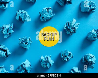 Backup plan message with crumpled blue paper balls on blue background. Business alternative backup plan concept. Stock Photo