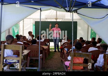 (190603) -- PAMPANGA PROVINCE, June 3, 2019 -- A teacher gives lessons to children from the indigenous group Aeta during the first day of classes in temporary classrooms of Diaz Elementary school in Pampanga Province, the Philippines, June 3, 2019. Temporary classrooms were set up after the Aeta community s classrooms were destroyed by the earthquake last April, as today marks the first day of new school year in the Philippines. ) PHILIPPINES-PAMPANGA PROVINCE-FIRST DAY OF SCHOOL ROUELLExUMALI PUBLICATIONxNOTxINxCHN Stock Photo