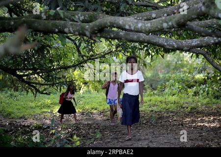 (190603) -- PAMPANGA PROVINCE, June 3, 2019 -- Children from the indigenous group Aeta walk to school during the first day of classes in temporary classrooms of Diaz Elementary school in Pampanga Province, the Philippines, June 3, 2019. Temporary classrooms were set up after the Aeta community s classrooms were destroyed by the earthquake last April, as today marks the first day of new school year in the Philippines. ) PHILIPPINES-PAMPANGA PROVINCE-FIRST DAY OF SCHOOL ROUELLExUMALI PUBLICATIONxNOTxINxCHN Stock Photo