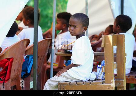 (190603) -- PAMPANGA PROVINCE, June 3, 2019 -- Children from the indigenous group Aeta attend class during the first day of classes in temporary classrooms of Diaz Elementary school in Pampanga Province, the Philippines, June 3, 2019. Temporary classrooms were set up after the Aeta community s classrooms were destroyed by the earthquake last April, as today marks the first day of new school year in the Philippines. ) PHILIPPINES-PAMPANGA PROVINCE-FIRST DAY OF SCHOOL ROUELLExUMALI PUBLICATIONxNOTxINxCHN Stock Photo