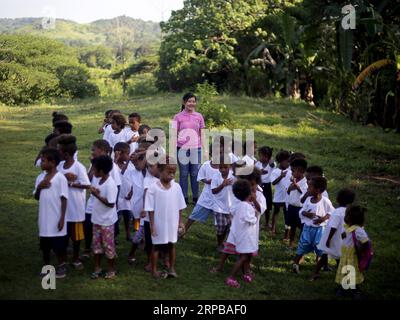 (190603) -- PAMPANGA PROVINCE, June 3, 2019 -- A teacher gives lessons to children from the indigenous group Aeta during the first day of classes in temporary classrooms of Diaz Elementary school in Pampanga Province, the Philippines, June 3, 2019. Temporary classrooms were set up after the Aeta community s classrooms were destroyed by the earthquake last April, as today marks the first day of new school year in the Philippines. ) PHILIPPINES-PAMPANGA PROVINCE-FIRST DAY OF SCHOOL ROUELLExUMALI PUBLICATIONxNOTxINxCHN Stock Photo