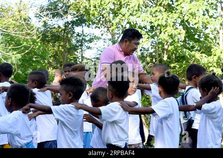 (190603) -- PAMPANGA PROVINCE, June 3, 2019 -- A teacher gives lessons to children from the indigenous group Aeta during the first day of classes in temporary classrooms of Diaz Elementary school in Pampanga Province, the Philippines, June 3, 2019. Temporary classrooms were set up after the Aeta community s classrooms were destroyed by the earthquake last April, as today marks the first day of new school year in the Philippines. ) PHILIPPINES-PAMPANGA PROVINCE-FIRST DAY OF SCHOOL ROUELLExUMALI PUBLICATIONxNOTxINxCHN Stock Photo