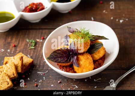 Homemade Fried Sicilian Arancini stuffed with meat, with tomato sauce Stock Photo