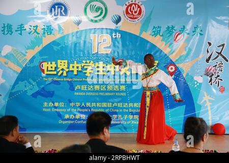 (190609) -- KIGALI, June 9, 2019 (Xinhua) -- A Rwandan student shows his talent during the overseas preliminary rounds of the 12th Chinese Bridge Chinese Proficiency Competition for Foreign Secondary School Students, in Kigali, capital of Rwanda, June 9, 2019. Rwanda s secondary school students from different parts of the country participated in the competition in Kigali on Sunday. (Xinhua/Lyu Tianran) RWANDA-KIGALI-CHINESE LANGUAGE COMPETITION-SECONDARY SCHOOL PUBLICATIONxNOTxINxCHN Stock Photo