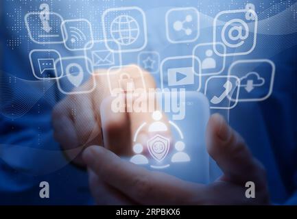 Man holds virtual mobile phone. Symbols and icons of 5G mobile internet, social networks, emails, cloud storage, multimedia services and so on. Mobile Stock Photo