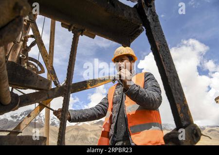 (190614) -- TAXKORGAN, June 14, 2019 (Xinhua) -- A worker operates a drilling machine at the construction site of a section of a highway linking Kashgar of China s Xinjiang Uygur Autonomous Region with Thakot of Pakistan, in northwest China s Xinjiang Uygur Autonomous Region, June 13, 2019. (Xinhua/Hu Huhu) CHINA-XINJIANG-HIGHWAY CONSTRUCTION (CN) PUBLICATIONxNOTxINxCHN Stock Photo