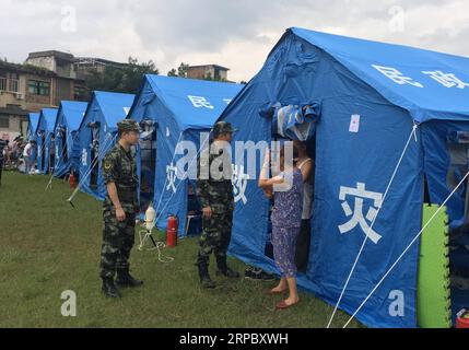 (190618) -- YIBIN, June 18, 2019 (Xinhua) -- Medical staff of armed police force visit people at a temporary shelter in Shuanghe Town High School in Changning County of Yibin City, southwest China s Sichuan Province, June 18, 2019. Thirteen people died and 199 were injured after a 6.0-magnitude earthquake hit southwest China s Sichuan Province at 10:55 p.m. Monday, the Ministry of Emergency Management said Tuesday. (Xinhua/Li Huashi) CHINA-SICHUAN-CHANGNING-EARTHQUAKE-DISASTER RELIEF (CN) PUBLICATIONxNOTxINxCHN Stock Photo