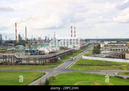 Industrial landscape. Panoramic view of the technological pipes. Plant settings. From the chemical red-white pipes smoke is coming. Production buildin Stock Photo