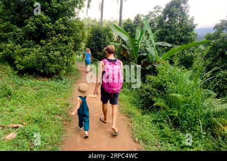 Family hiking in jungle, Kintamani, Bali, Indonesia Stock Photo