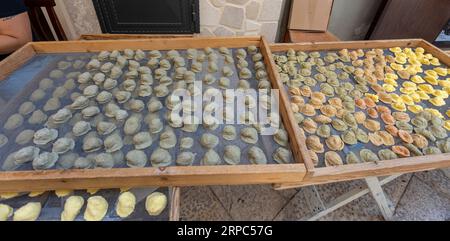 Exposure of the famous Apulian orecchiette, a type of fresh handmade pasta on the street by housewives in Bari Vecchia, Apulia, Italy. Stock Photo