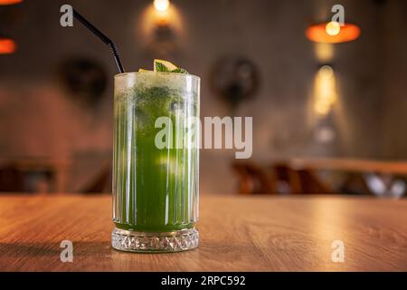 Green cocktail with fresh mint, lemon and crushed kiwi in a tall glass Stock Photo