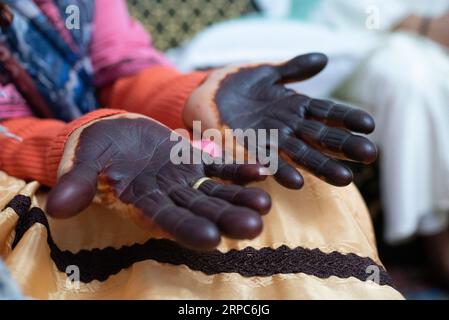 Close up of elderly woman painted hands with henna in celebration. Stock Photo