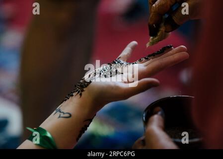 Close up of painted hand woman with henna in a party in Morocco. Stock Photo