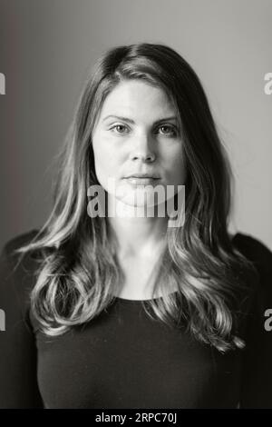 A black and white image of a young woman looking direct and confident Stock Photo