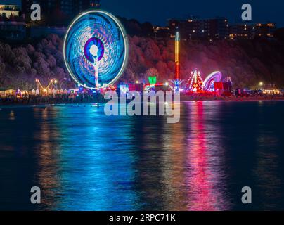 The funfair at night. BOURNEMOUTH; UK: EXTRAORDINARY images show exciting aerial displays from Bournemouth Air Festival over the weekend. It is the UK Stock Photo