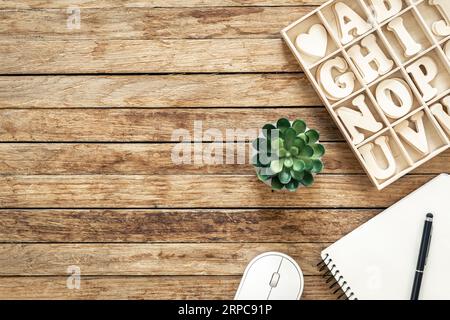 Set of wooden letters of the English alphabet and a notepad on a wooden background, top view. Stock Photo