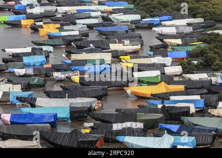 (190628) -- BEIJING, June 28, 2019 () -- Indian fishing boats covered with tarpaulins are anchored near the Arabic Seashore on the outskirts of Mumbai, India, June 26, 2019. The local fishermen stop fishing during the monsoon season due to continuous rain and uncertain wind conditions. () PHOTOS OF THE DAY Xinhua PUBLICATIONxNOTxINxCHN Stock Photo