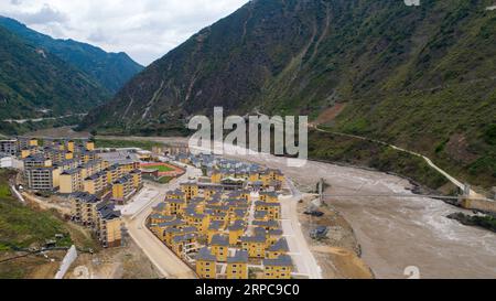 (190628) -- KUNMING, June 28, 2019 -- Aerial photo taken on June 24, 2019 shows a resettlement site for people of Lisu ethnic group in Daxingdi Town, Lisu Autonomous Prefecture of Nujiang, southwest China s Yunnan Province. Lisu people have been relocated to a new community from unlivable mountain areas thanks to the poverty alleviation policy by local government. Zhiguo minorities are special members of China s 56 ethnic groups. The term Zhiguo refers to minority groups who, before modernization, had lived in relative isolation and skipped the transition period associated with feudal monarchy Stock Photo