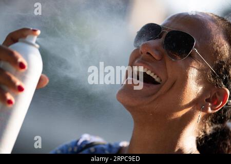 (190628) -- PARIS, June 28, 2019 -- A woman uses water spray to cool herself in Paris, France, June 27, 2019. The national weather center, Meteo France, on Thursday warned of exceptional heat peak on June 28, placing 4 southern regions on red alert, the highest alert on the agency s four-scale system, and urges residents to be extremely vigilant. While 76 other regions, except Brittany, in northwest France, remain on orange alert till next week. Jack Chan) FRANCE-PARIS-HEAT WAVE JiexKe¤chen PUBLICATIONxNOTxINxCHN Stock Photo