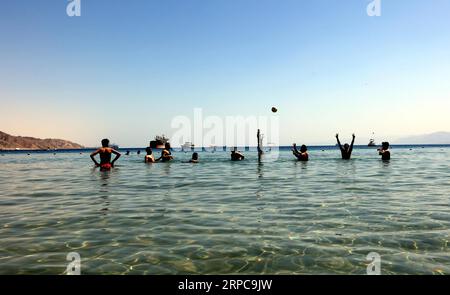 (190628) -- AQABA (JORDAN), June 28, 2019 -- Tourists play water volleyball in the Red Sea in the southern port city of Aqaba, Jordan, on June 28, 2019. Aqaba attracts tourists from Jordan and abroad to enjoy their summer holidays with its famous beaches and various water sports. ) JORDAN-AQABA-RED SEA-TOURISM MohammadxAbuxGhosh PUBLICATIONxNOTxINxCHN Stock Photo