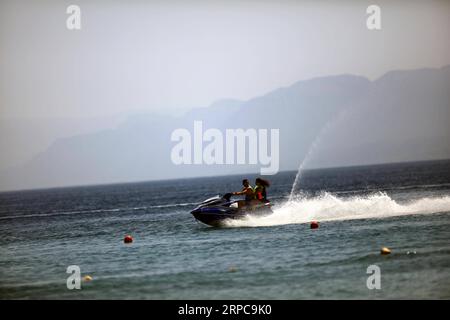 (190628) -- AQABA (JORDAN), June 28, 2019 -- Tourists ride a jet ski in the Red Sea in the southern port city of Aqaba, Jordan, on June 28, 2019. Aqaba attracts tourists from Jordan and abroad to enjoy their summer holidays with its famous beaches and various water sports. ) JORDAN-AQABA-RED SEA-TOURISM MohammadxAbuxGhosh PUBLICATIONxNOTxINxCHN Stock Photo