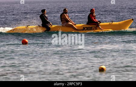 (190628) -- AQABA (JORDAN), June 28, 2019 -- Tourists ride a banana boat in the Red Sea in the southern port city of Aqaba, Jordan, on June 28, 2019. Aqaba attracts tourists from Jordan and abroad to enjoy their summer holidays with its famous beaches and various water sports. ) JORDAN-AQABA-RED SEA-TOURISM MohammadxAbuxGhosh PUBLICATIONxNOTxINxCHN Stock Photo