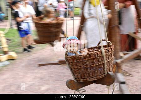 (190701) -- BEIJING, July 1, 2019 -- A child enjoys a manually-operated merry-go-round in Turku, southwestern Finland, on June 29, 2019. The annual Medieval Market, one of the largest historical events in Finland, is held in Turku from June 27 to June 30. Modern people can enjoy ancient music and dance, historical street plays, traditional food and handicrafts during the event. ) XINHUA PHOTOS OF THE DAY ZhangxXuan PUBLICATIONxNOTxINxCHN Stock Photo