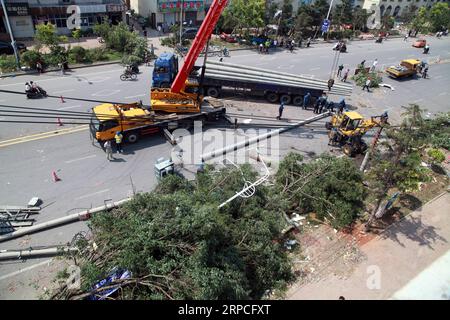 (190704) -- SHENYANG, July 4, 2019 (Xinhua) -- Rescuers clean the road and fix the power wires at a residential area impacted by tornado in Kaiyuan City, northeast China s Liaoning Province, July 4, 2019. An emergency medical expert team has rushed to Kaiyuan in northeast China s Liaoning Province to help with treating the injured following a deadly tornado Wednesday afternoon, the National Health Commission (NHC) said. The disaster left six people dead and over 190 others injured. Of the injured, 63 are still being treated at six hospitals, according to local authorities. (Xinhua) CHINA-LIAON Stock Photo