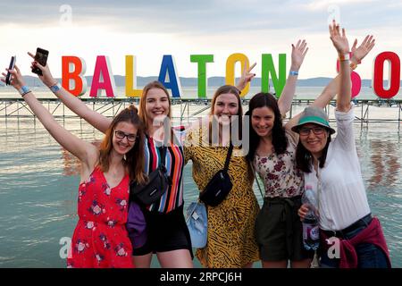 (190706) -- ZAMARDI, July 6, 2019 -- People take photos in front of the logo of Balaton Sound music festival on the shore of Lake Balaton in Zamardi, Hungary, on July 5, 2019. ) HUNGARY-ZAMARDI-BALATON SOUND-MUSIC FESTIVAL AttilaxVolgyi PUBLICATIONxNOTxINxCHN Stock Photo