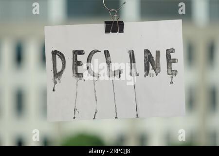 grungy decline sign, economic crisis,business and economic activities concept, blurred office building in the back Stock Photo