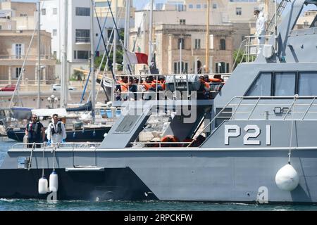 (190708) -- FLORIANA, July 8, 2019 -- Rescued migrants are seen on the deck of the Armed Forces of Malta patrol boat P21, in Floriana, Malta, on July 7, 2019. A group of 58 migrants was rescued by the Armed Forces of Malta (AFM) on Sunday morning. ) MALTA-FLORIANA-RESCUED MIGRANTS JonathanxBorg PUBLICATIONxNOTxINxCHN Stock Photo