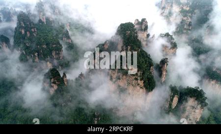 (190708) -- BEIJING, July 8, 2019 -- Aerial photo taken on May 26, 2019 shows a view of the Wulingyuan Scenic Area in Zhangjiajie, central China s Hunan Province. Located in central China, Hunan Province is well-known for its varied topography. It abuts the Dongting Lake to the north, and the east, south and west sides of the province are surrounded by mountains, with Wuling and Xuefeng Mountains to the west, Nanling Mountain to the south, Luoxiao and Mufu Mountains to the east. The Xiangjiang, Zijiang, Yuanjiang and Lishui Rivers converge on the Yangtze River at the Dongting Lake in the north Stock Photo