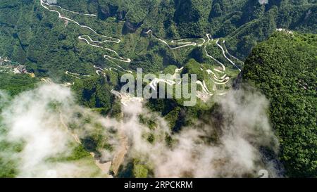 (190708) -- BEIJING, July 8, 2019 -- Aerial photo taken on May 31, 2019 shows a view of the Tianmen Mountain Scenic Area in Zhangjiajie, central China s Hunan Province. Located in central China, Hunan Province is well-known for its varied topography. It abuts the Dongting Lake to the north, and the east, south and west sides of the province are surrounded by mountains, with Wuling and Xuefeng Mountains to the west, Nanling Mountain to the south, Luoxiao and Mufu Mountains to the east. The Xiangjiang, Zijiang, Yuanjiang and Lishui Rivers converge on the Yangtze River at the Dongting Lake in the Stock Photo