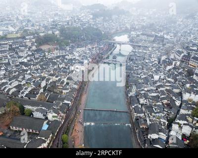 (190708) -- BEIJING, July 8, 2019 -- Aerial photo taken on Jan. 10, 2019 shows a view of the Fenghuang ancient town in Fenghuang County, central China s Hunan Province. Located in central China, Hunan Province is well-known for its varied topography. It abuts the Dongting Lake to the north, and the east, south and west sides of the province are surrounded by mountains, with Wuling and Xuefeng Mountains to the west, Nanling Mountain to the south, Luoxiao and Mufu Mountains to the east. The Xiangjiang, Zijiang, Yuanjiang and Lishui Rivers converge on the Yangtze River at the Dongting Lake in the Stock Photo