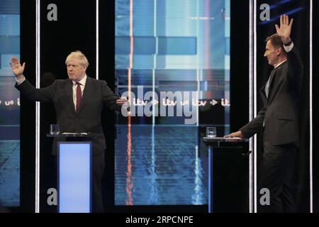 (190710) -- SALFORD, July 10, 2019 -- In this handout image provided by ITV, Boris Johnson and Jeremy Hunt (L-R) take part in the Jeremy Hunt and Boris Johnson debate Head To Head on ITV in Salford, Britain, on July 9, 2019. Conservative Party leadership front-runner Boris Johnson repeated his pledge Tuesday to being Britain out of the European Union on Oct. 31 if he wins the battle to become the next prime minister. But in a head-to-head live televised debate with his rival, Foreign Secretary Jeremy Hunt, Johnson refused to say whether he would resign if he failed, and he would not be drawn o Stock Photo