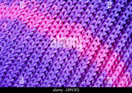 Pattern fabric made of wool. Handmade knitted fabric purple wool background texture Stock Photo