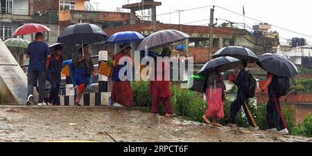 (190712) -- KATHMANDU, July 12, 2019 -- People walk in the rain in Kathmandu, Nepal, July 12, 2019. Nepal has been hit by heavy rainfall since Thursday evening. ) NEPAL-KATHMANDU-MONSOON-RAINFALL sunilxsharma PUBLICATIONxNOTxINxCHN Stock Photo