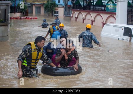 (190712) -- KATHMANDU, July 12, 2019 -- Nepalese army personnel rescue local people after a heavy rainfall in Kathmandu, Nepal, July 12, 2019. Nepal was hit by heavy rainfall that caused floods and landslides in many places. ) NEPAL-KATHMANDU-FLOOD-RESCUE sulavxshrestha PUBLICATIONxNOTxINxCHN Stock Photo