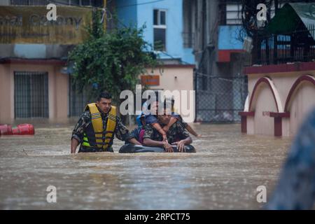 (190712) -- KATHMANDU, July 12, 2019 -- Nepalese army personnel rescue local people after a heavy rainfall in Kathmandu, Nepal, July 12, 2019. Nepal was hit by heavy rainfall that caused floods and landslides in many places. ) NEPAL-KATHMANDU-FLOOD-RESCUE sulavxshrestha PUBLICATIONxNOTxINxCHN Stock Photo