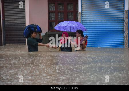 News Bilder des Tages (190712) -- KATHMANDU, July 12, 2019 -- People tread in the flood in Kathmandu, Nepal, July 12, 2019. Many areas in Nepal were inundated by the swollen Balkhu river following torrential rains since Thursday night. ) NEPAL-KATHMANDU-RAIN-FLOOD sunilxsharma PUBLICATIONxNOTxINxCHN Stock Photo