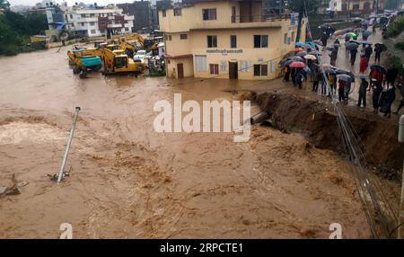 (190712) -- KATHMANDU, July 12, 2019 -- People watch the swollen Balkhu River that floods the street in Kathmandu, Nepal, July 12, 2019. Many areas in Nepal were inundated by the swollen Balkhu river following torrential rains since Thursday night. ) NEPAL-KATHMANDU-RAIN-FLOOD sunilxsharma PUBLICATIONxNOTxINxCHN Stock Photo